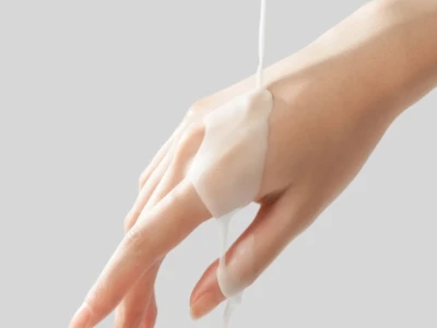 Hands lathering soap in a shower