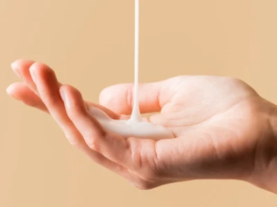Hands lathering soap in a shower.